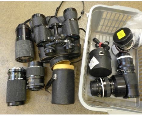 A collection of camera lenses and a pair of binoculars
