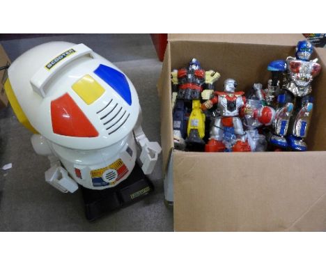 A box of plastic robots and a Scooter 2000 large robot