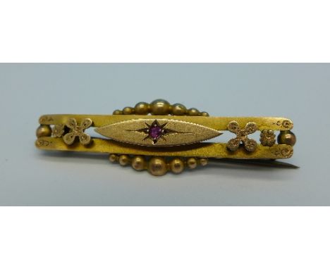 A 9ct gold brooch set with a ruby, 2.5g