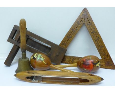 A hand bell, a pair of maracas, a football rattle, a lace bobbin and a triangular cribbage board (5)