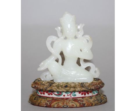 A CHINESE CELADON JADE-LIKE FIGURE OF AMITAYUS BUDDHA, seated in a meditative posture, together with a fitted fabric covered 