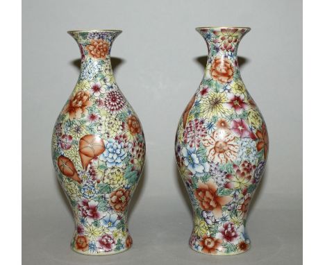 A SMALL PAIR OF CHINESE FAMILLE ROSE MILLEFLEUR PORCELAIN VASES, each baluster form body decorated with a profusion of overla