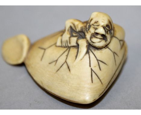AN UNUSUAL 19TH CENTURY SIGNED JAPANESE IVORY NETSUKE OF A MAN ESCAPING FROM A CLAM, the man holding a cutting implement and 