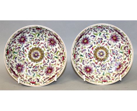 A PAIR OF CHINESE FAMILLE ROSE PORCELAIN SAUCER DISHES, each decorated in vivid enamels with bats and formal scroll-stemmed l