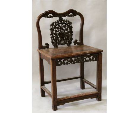 A 19TH CENTURY CHINESE CARVED HARDWOOD CHAIR, of rectangular section, the pierced back panel carved with a circular panel of 