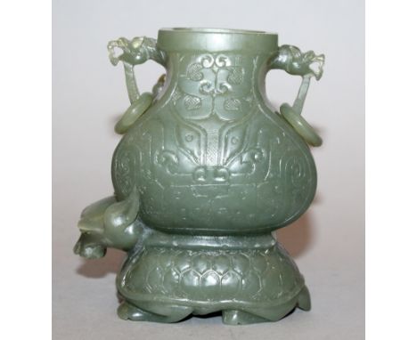 A CHINESE GREEN TURTLE-DRAGON JADE VASE, the mythical creature supporting on its back a vase carved in low relief to one side