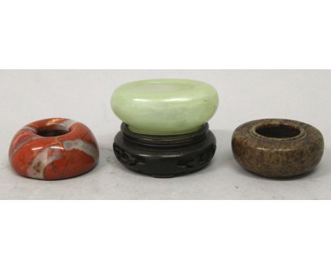A SMALL CHINESE OVAL CELADON JADE-LIKE BRUSHWASHER, 2.75in wide & 1.1in high; together with two similarly sized stone example
