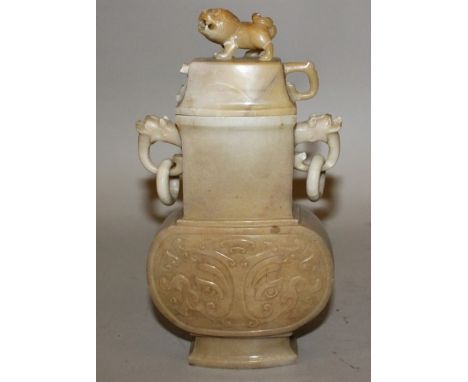 A CHINESE JADE-LIKE VASE OF ARCHAIC FORM, with double loose ring handles, the sides decorated with taotie masks, the stone of