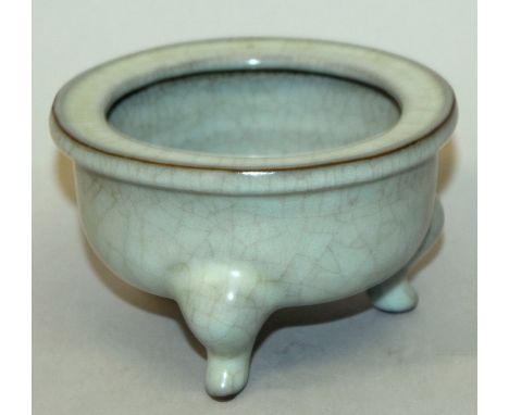 A CHINESE CELADON CRACKLEGLAZE PORCELAIN TRIPOD CENSER, with a flanged rim, 5.25in diameter at rim & 3.2in high.