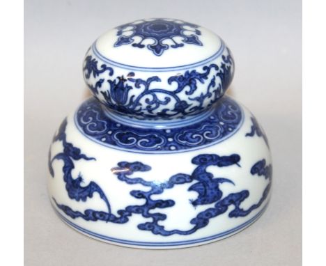 A CHINESE BLUE & WHITE PORCELAIN SCROLL WEIGHT, of circular section, decorated with formal borders and a design of bats amids