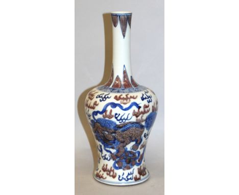 A CHINESE UNDERGLAZE-BLUE & COPPER-RED PORCELAIN VASE, the sides decorated with buddhistic lions playing with ribboned balls 