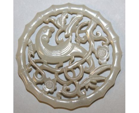 A GOOD 18TH/19TH CENTURY CHINESE PIERCED CIRCULAR CELADON JADE PLAQUE, with a carved bamboo form surround, the interior carve