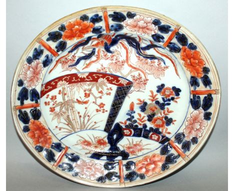 A JAPANESE MEIJI PERIOD IMARI PORCELAIN OVAL DISH, circa 1900, the interior painted with a ho-ho phoenix above a garden setti