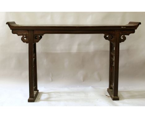 A 19TH/20TH CENTURY CHINESE CARVED HARDWOOD SCROLL END ALTER TABLE, the narrow top surface supported on two pierced rectangul