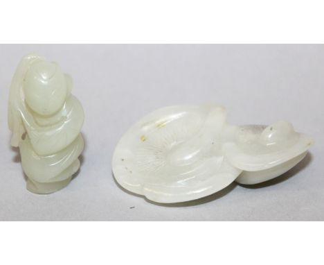 A CHINESE CELADON JADE-LIKE GROUP OF TWO MUSHROOMS, 2.3in wide; together with a small celadon jade-like figure of a boy holdi