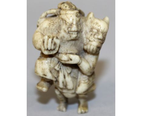 A 19TH CENTURY JAPANESE BONE IVORY NETSUKE OF SHOKI GRAPPLING WITH AN ONI, 1.8in high.