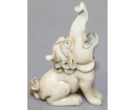 A 19TH/20TH CENTURY JAPANESE CARVED IVORY NETSUKE OF A BAKU, seated with raised trunk, 1.9in high.