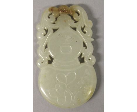 A CHINESE PIERCED CELADON JADE-LIKE PENDANT, in the form of a scroll-handled double gourd vase, 2.4in high. 