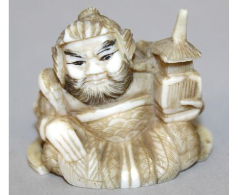 A SIGNED 19TH/20TH CENTURY JAPANESE CARVED IVORY NETSUKE OF SHOKI, 1.6in wide.