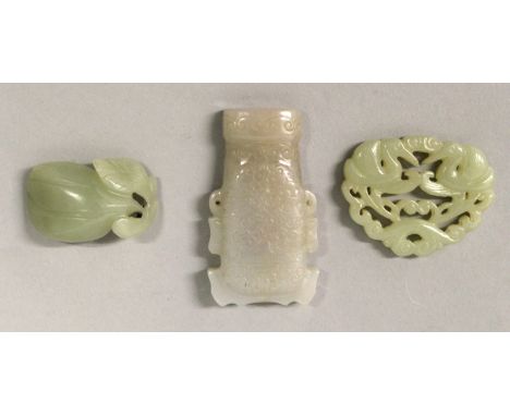 A CHINESE PIERCED CELADON JADE-LIKE PLAQUE, decorated with a pair of cranes and scrolling foliage, 2.1in wide; together with 