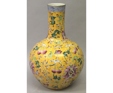 A LARGE CHINESE YELLOW GROUND PORCELAIN BOTTLE VASE, the sides decorated with a formal arrangement of leaf and scroll stemmed