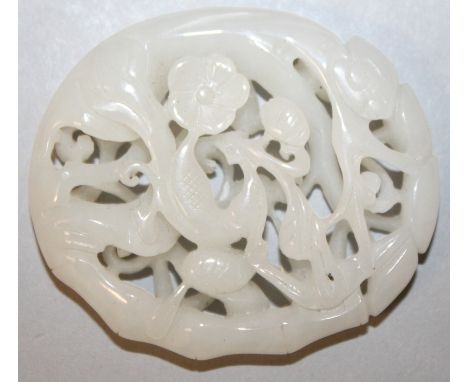 A GOOD 18TH/19TH CENTURY CHINESE PIERCED OVAL WHITE JADE PLAQUE, deeply carved with an exotic bird amidst bamboo, lingzhi and