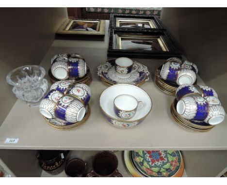 A 19th century part tea service in gilt heightened floral pattern18 cups, 11 saucers, 13 side plates, 2 cake plates and 1 dis