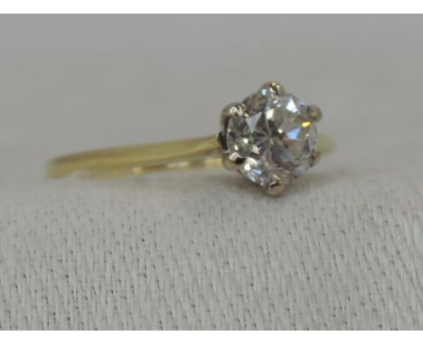 A lady's dress ring having a diamond solitaire, approx 0.70ct in claw set raised mount to knife blade shoulders on an 18ct go