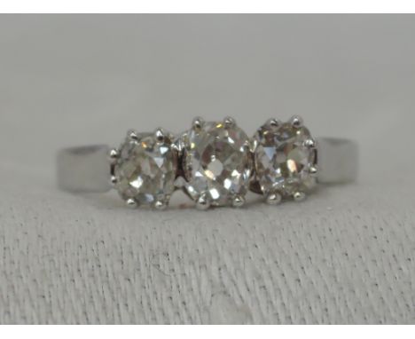 A lady's dress ring having a trilogy of old cut diamonds, total approx 1ct in a claw set mount on a white metal loop stamped 