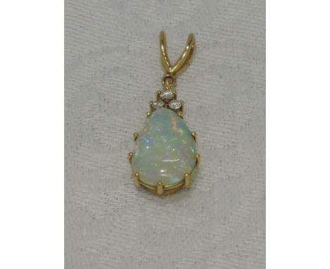 A teardrop opal pendant with a trilogy of diamonds to 18ct gold claw set mount on a double loop5mm wide x 15mm length