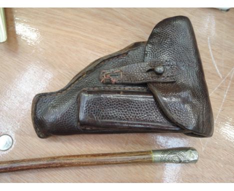 A leather military pistol holster and a Royal Engineers swagger stick