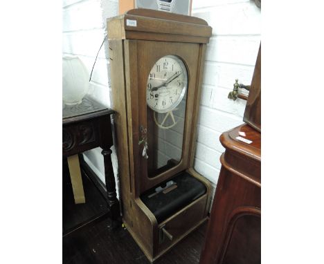 A vintage oak cased clocking in clock labelled Fried Ernst Benzing Schwenningen Wurt, of traditional design
