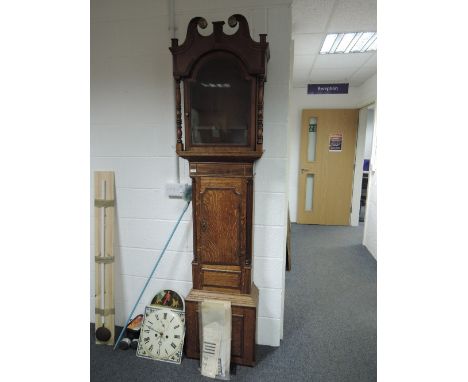 A late 18th century oak longcase clock having swan neck and pillar hood, containing painted arch dial and 8 day movement, on 