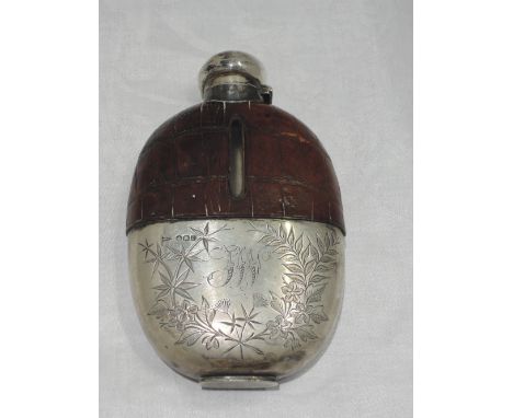 A Victorian spirit flask having crocodile leather cover, silver bayonet cap and cup with engraved decoration and monogram,  S