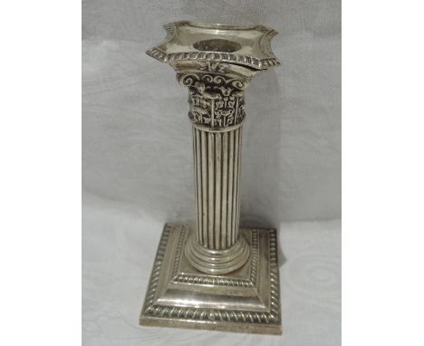 A silver candle stick of Corinthian column form having a stepped weighted base and removeable sconse,  Birmingham 1911, Walke