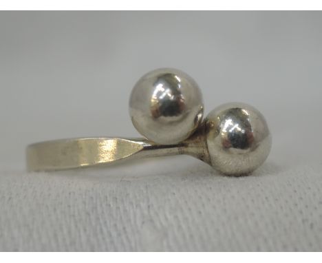 A Norwegian silver dress ring having crossover ball terminals, size O