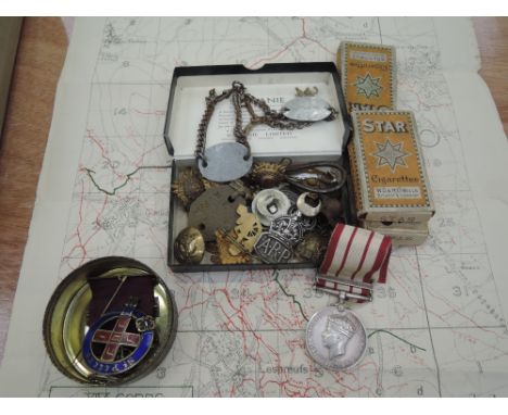 A small collection of military items including badges, buttons, identity bracelet x 2 World War I, dog tag, World War I trenc