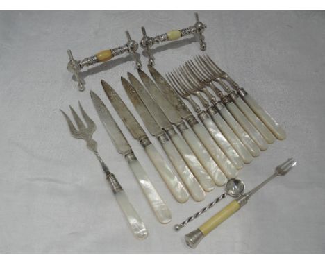 A six setting set of dessert fruit knives and forks having mother of pearl handles, engraved silver plated blades and HM silv