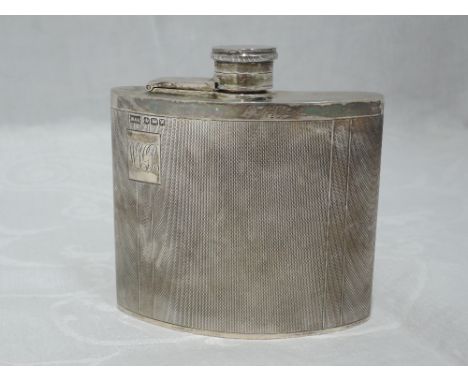 A silver hip flask of half moon form having engine turned decoration and monogrammed cartouche with bayonet lid, Sheffield 19