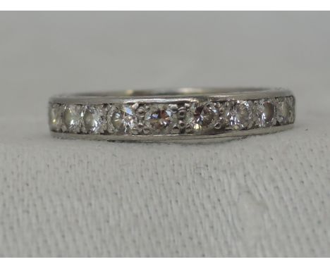 A lady's full eternity ring having 22 diamonds, approx 1ct in a pave mount on white metal loop, no marks possibly platinum,  