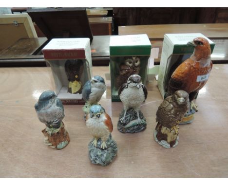 Seven Royal Doulton whisky birds, one empty Royal Doulton bird and one Beswick Golden Eagle Beneagle Whisky decanter 