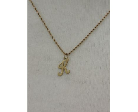 A yellow metal gold fine rope chain stamped 9ct with K initial pendant, approx 18'weight 3.2g