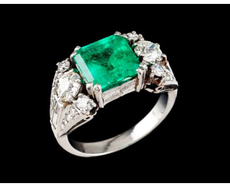 A ringPlatinum Set with one Colombian emerald cut  emerald (ca. 2.50ct) two antique cut diamonds totalling (ca. 0.95ct) 20 br