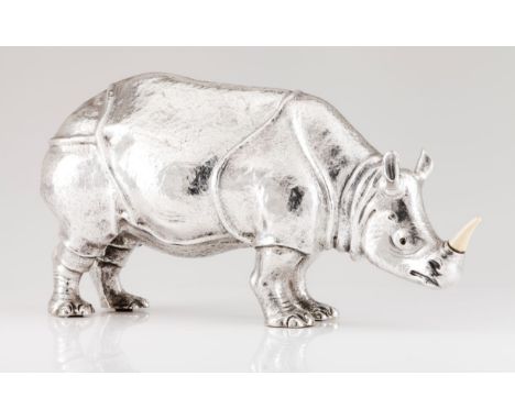 A large Manuel Alcino rhinocerosRepoussé and chiselled Portuguese silver sculpture with applied ivory horn Oporto 833/000 ass