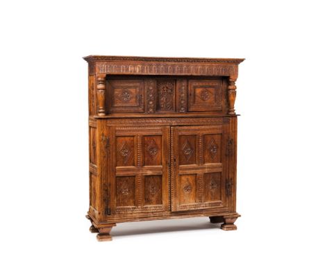 A cupboardOak Upper section with central panel of stylised figure decoration flanked  by two doors with foliage friezes and c