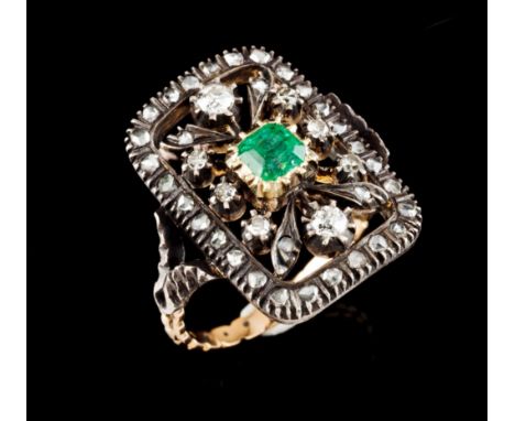 A Romantic era ringSilver and gold Rectangular shaped body of pierced geometric decoration set with one square cut emerald (c