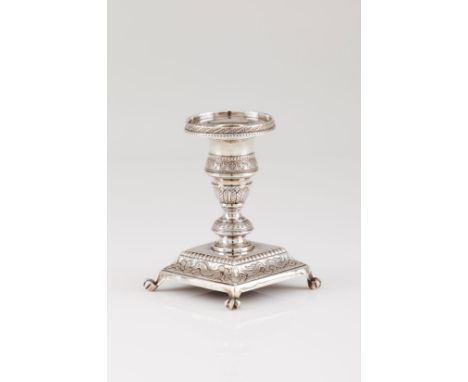 A low candle stickPortuguese silver, 19th century Turned shaft engraved with palm frieze and beading, on a square stand with 