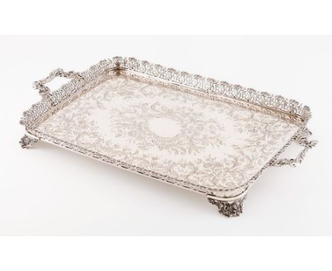 A trayPortuguese silver Rectangular shaped of rounded corners and profuse engraved and chiselled decoration with foliage moti