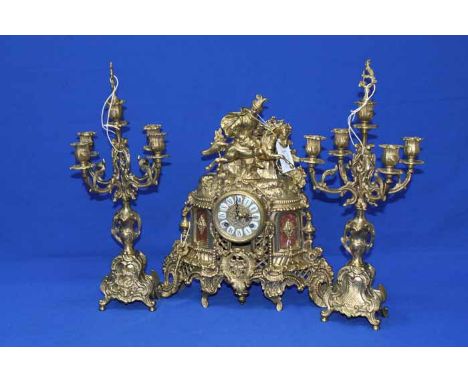 BRASS MANTEL CLOCK GARNITURE
clock with case brass c-scroll and Baroque style decoration, topped with a figure on a galloping