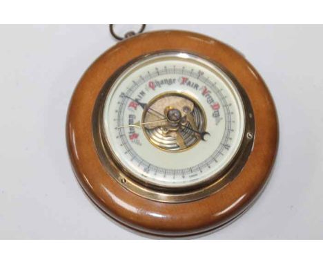 SMALL WALL HANGING BAROMETER
cream enamel dial in a turned wooden case with loop fixture, 13cm in diameter
